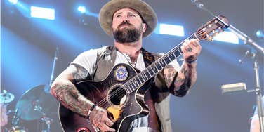 Singer Zac Brown standing on stage with guitar. 