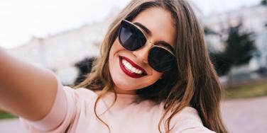 woman smiling with sunglasses