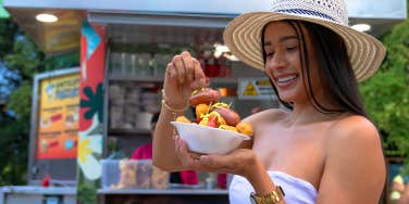 girl eating kebab from food truck