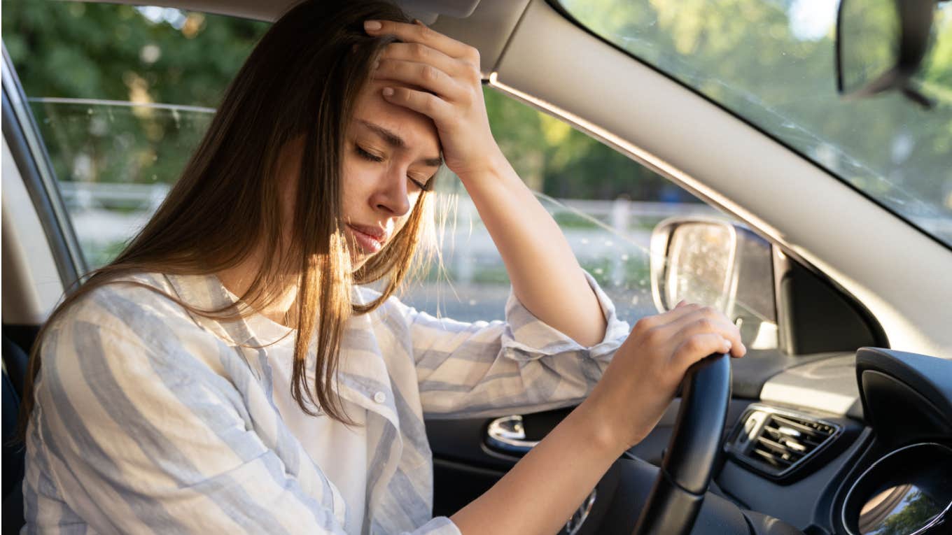 woman experiences nausea and headache while driving