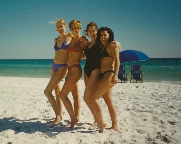 four high school senior girls pose in swimsuits on the beach in Florida, 1996