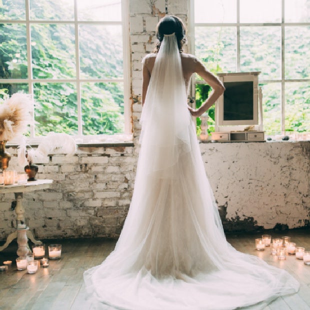 bride on her wedding day looking out the window