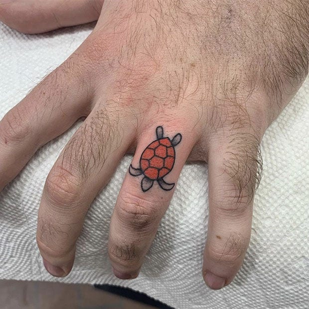 Colorful turtle wedding ring tattoo