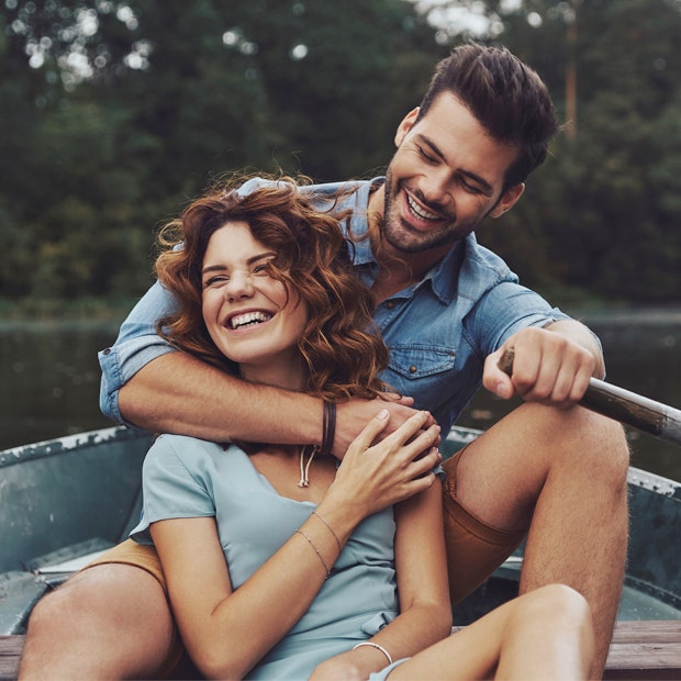 couple smiling in a boat man&#039;s arm around woman signs he&#039;s your soulmate