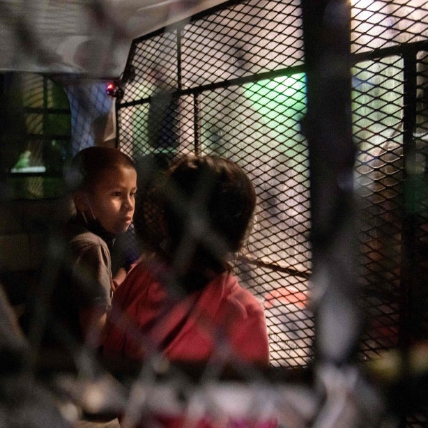 Two unaccompanied migrant children at a processing checkpoint in Roma, Texas