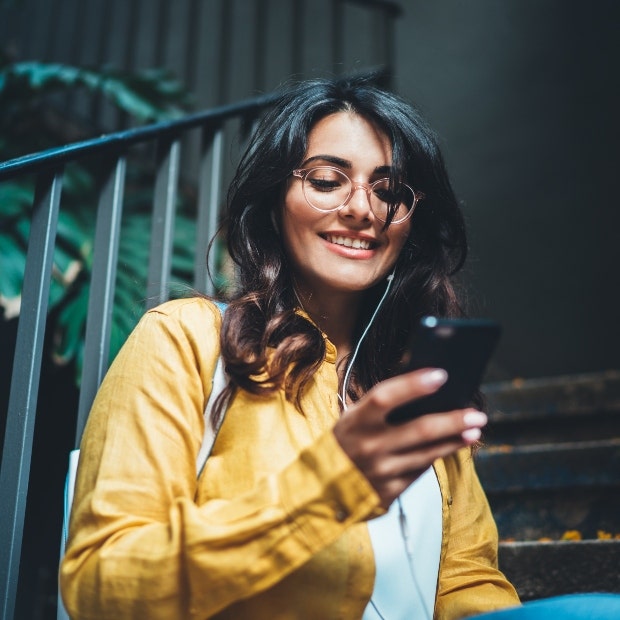 woman in stairwell texting