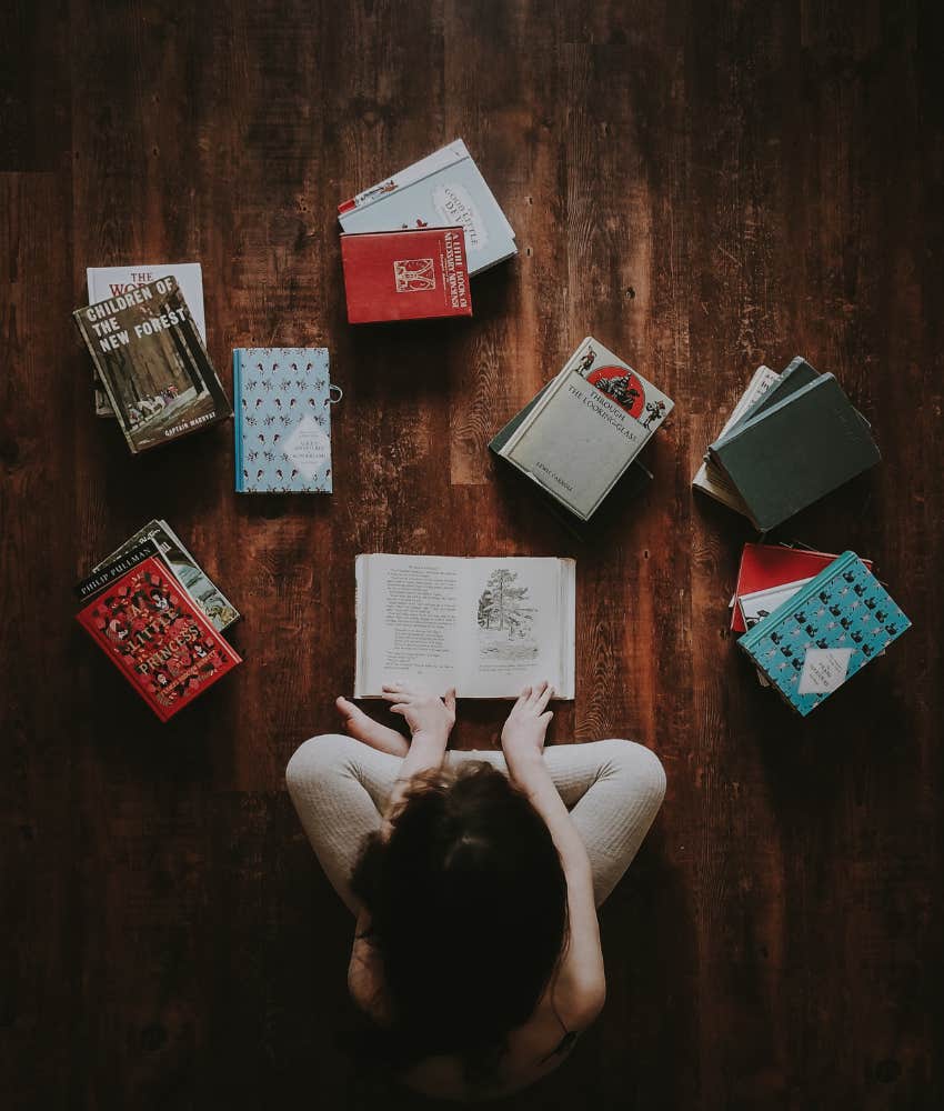 person sitting on the floor with books