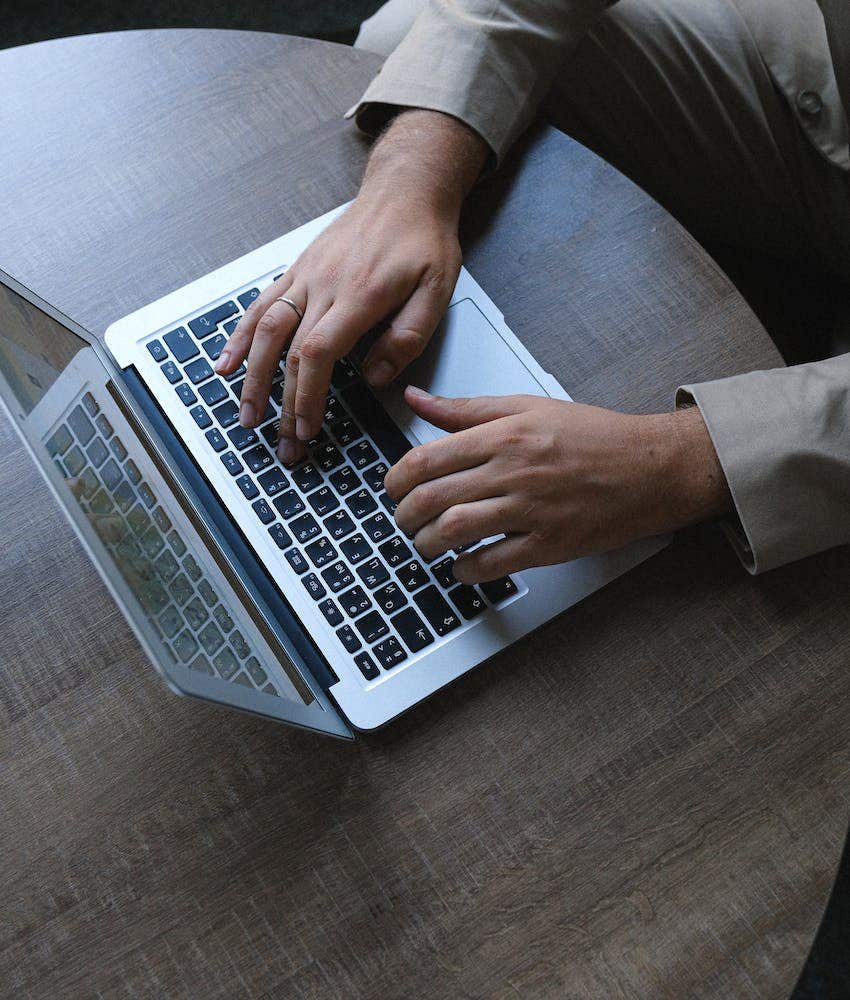 person typing on a laptop