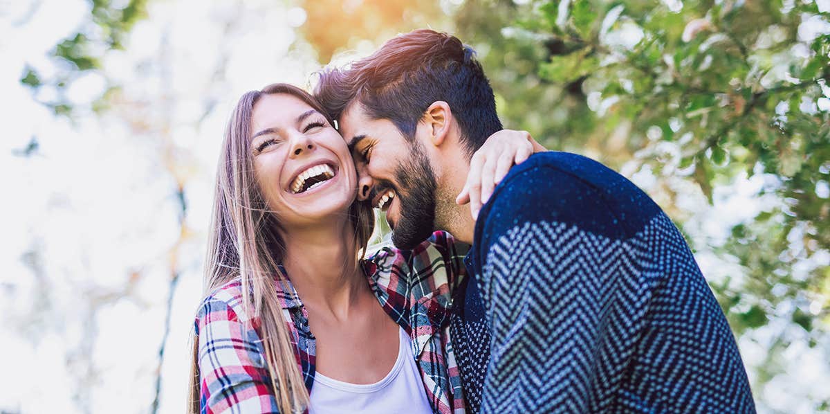 Happy couple in love having fun outdoors and smiling.