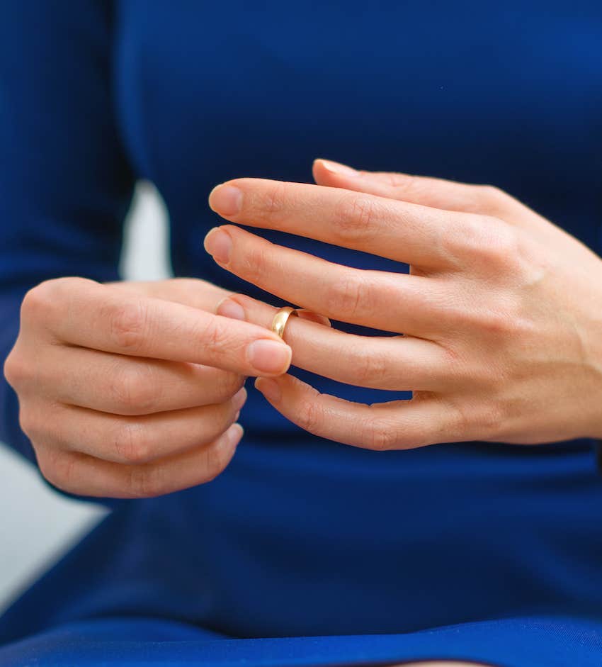 woman removes her wedding ring
