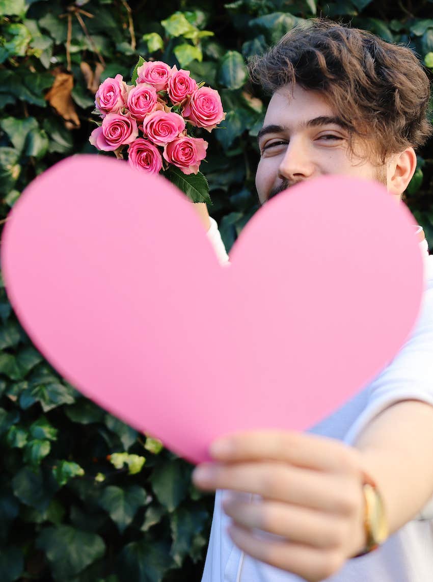 man giving paper heart