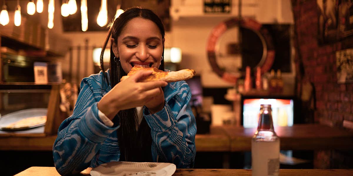 Happy and satisfied foodie having tasty supper at a diner