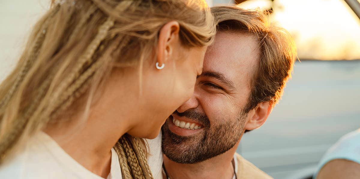 6 Things People Only Do If They Really Love You, According To Research White couple hugging and smiling during picnic with their friends outdoors
