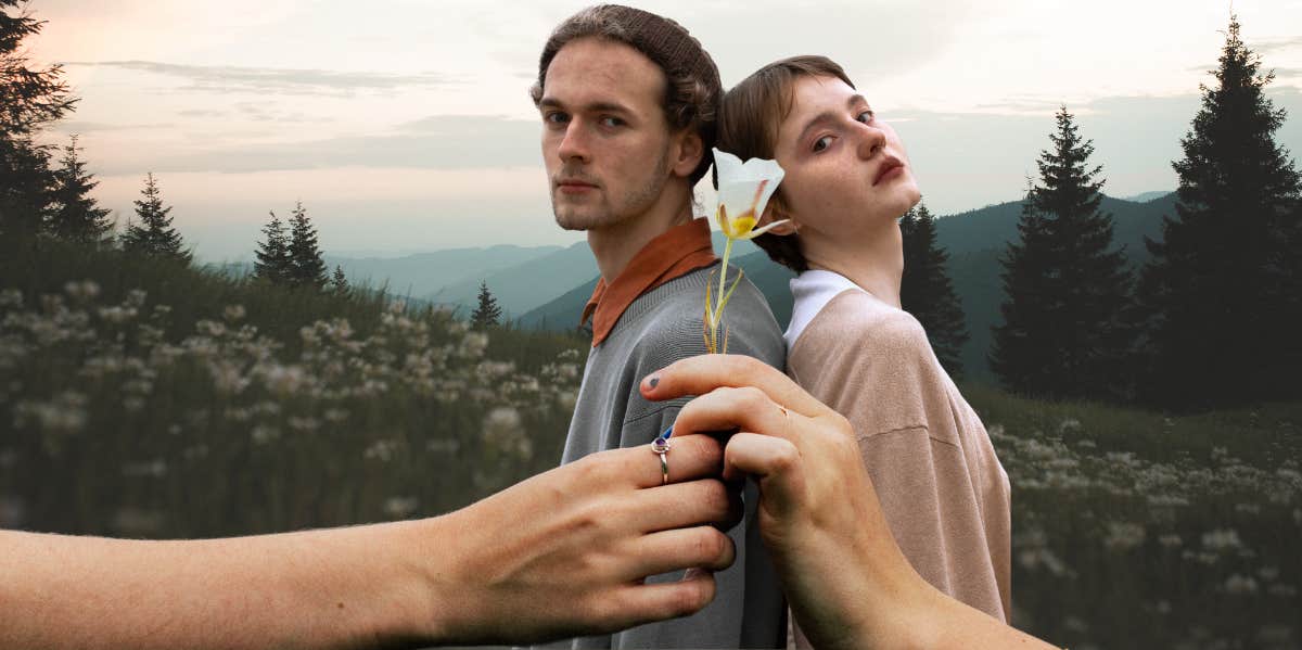 man and woman in a field, hands holding a flower together