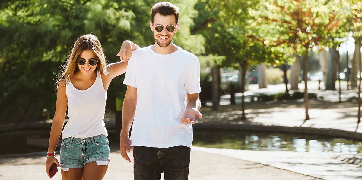 Portrait of beautiful young couple walking in the park.