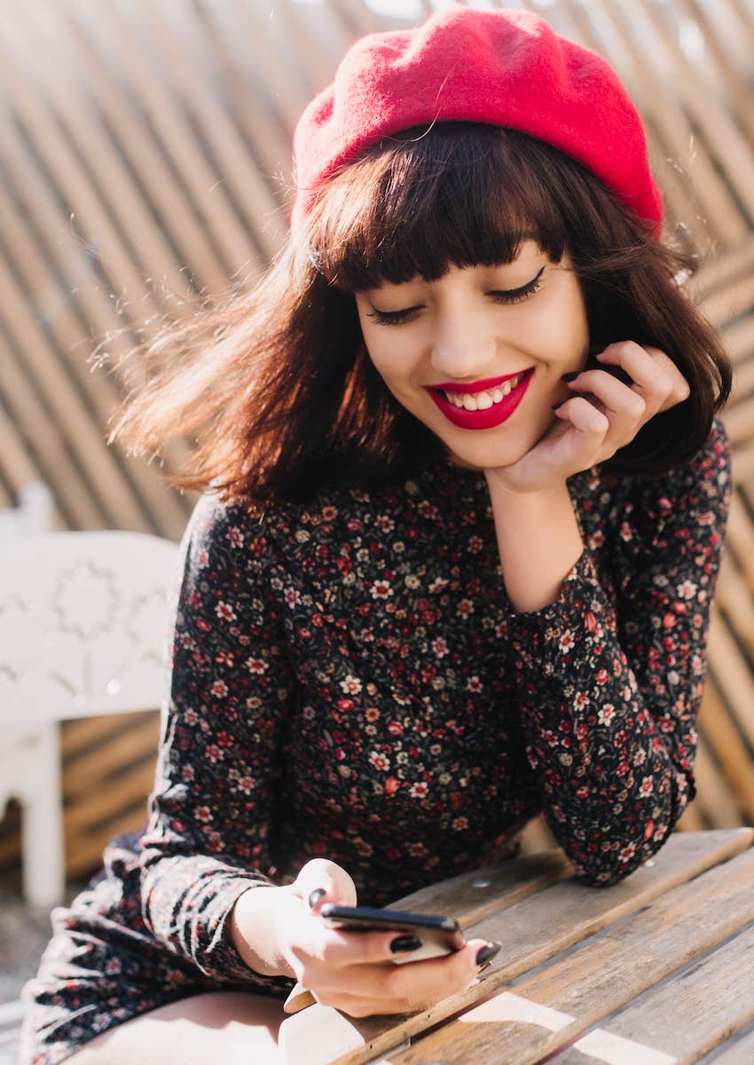 Woman smiling at her phone