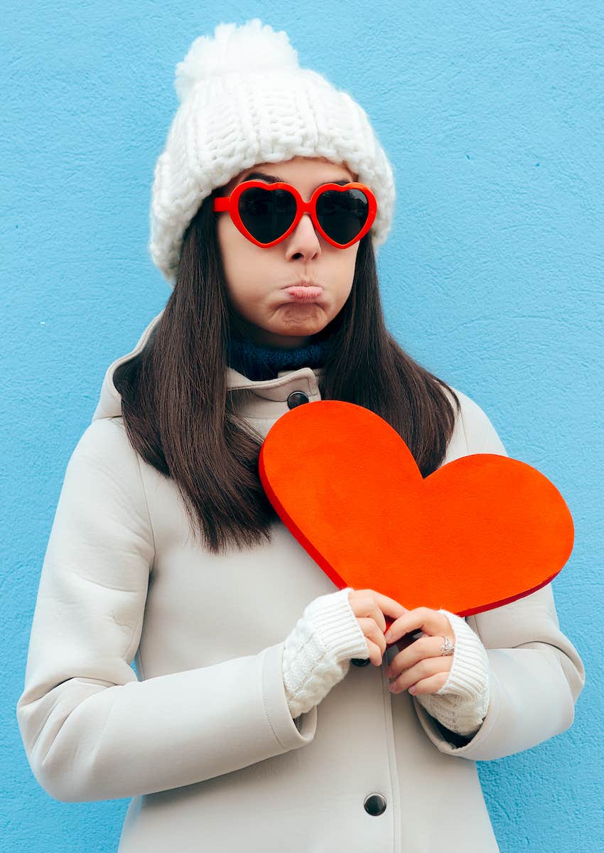 sad woman holds heart