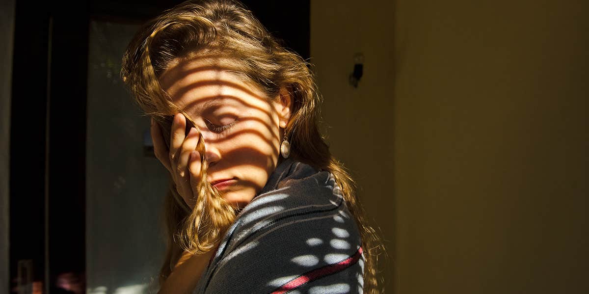 portrait of a girl in the light through the blinds