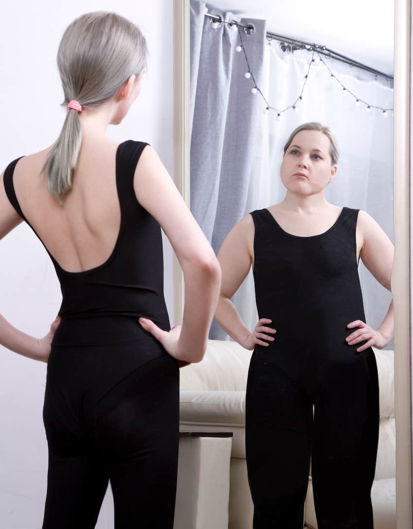 woman misperceives body image in mirror