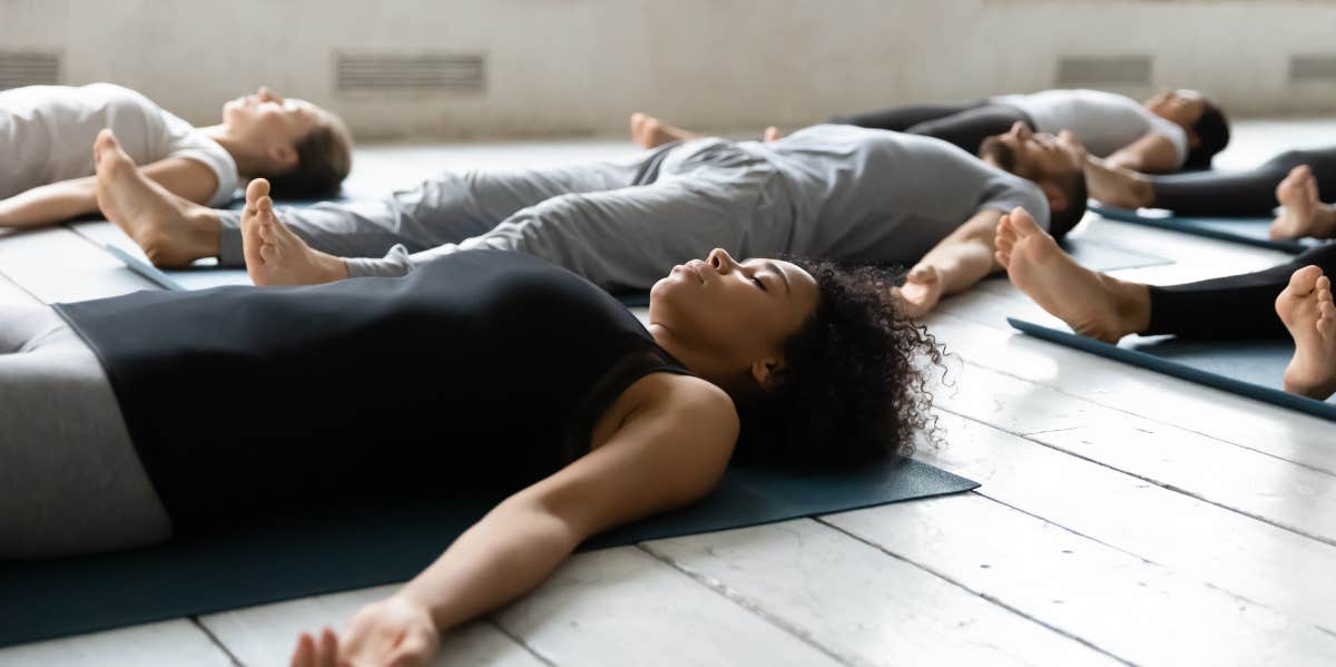 woman grounding herself in Shavasana