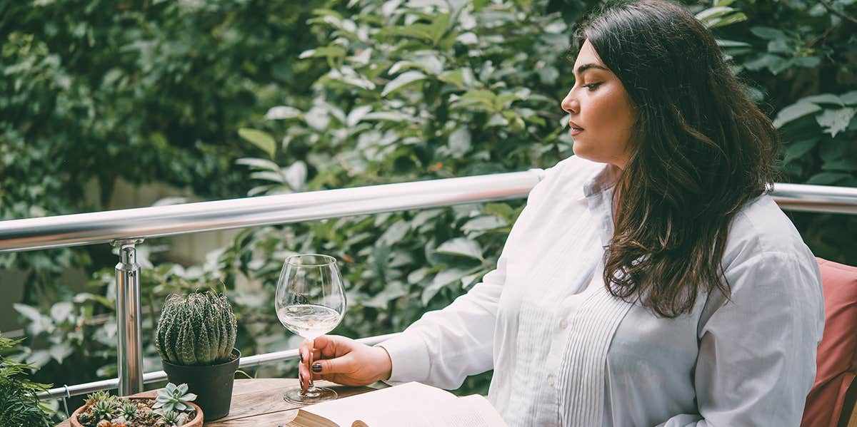 plus size woman looking sad while dining alone