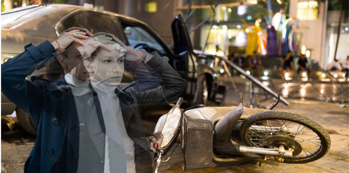 Woman feeling out of body, standing in front of a accident with a motorcycle 