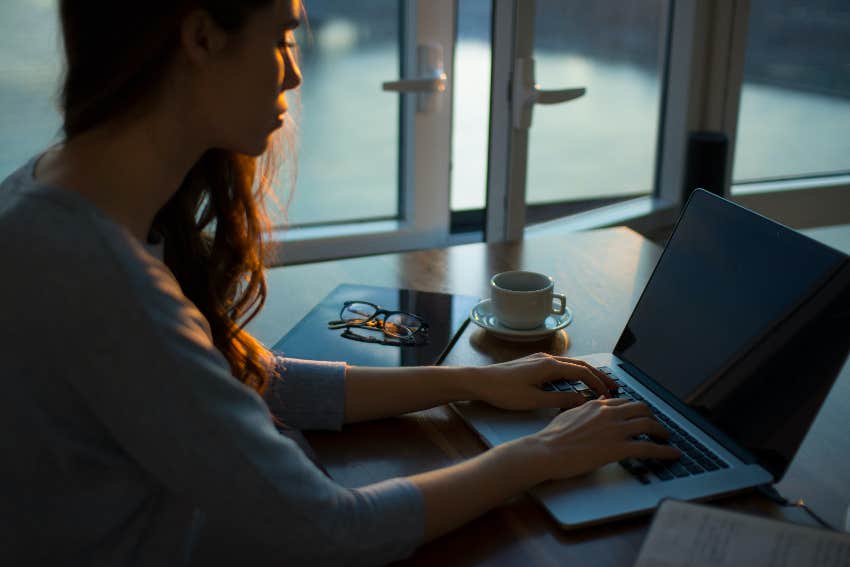 asian woman typing on a laptop