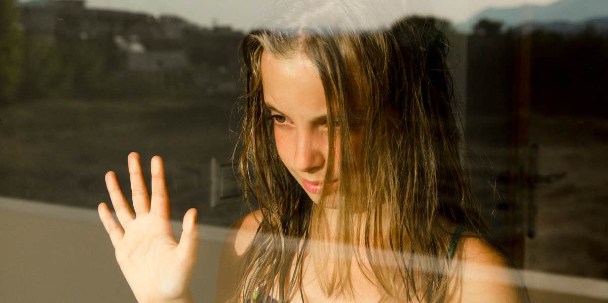 This Specific Type Of Parent Raises Extremely Anxious Kids, According To Research anxious child gazing out of window