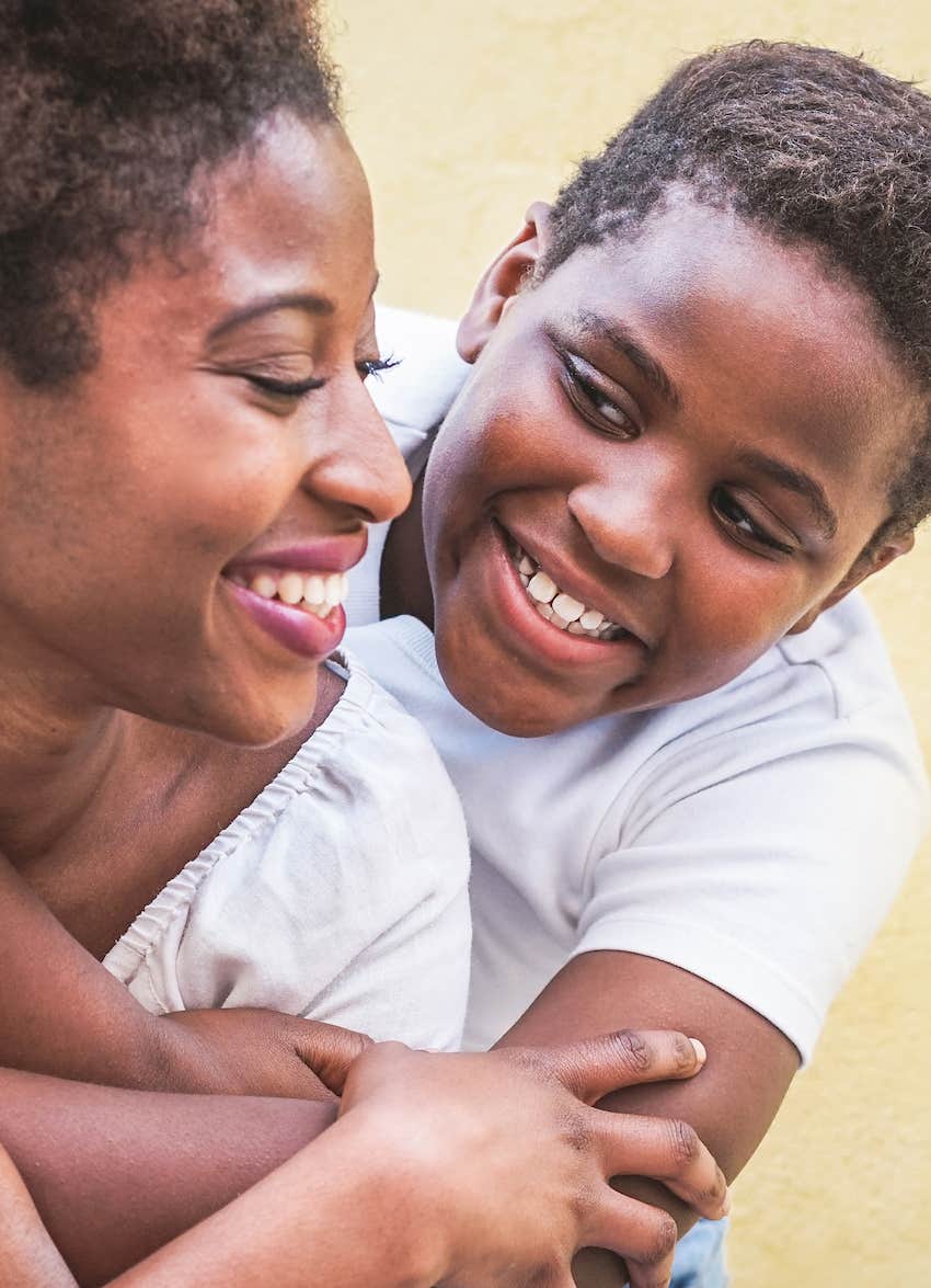 joyful mother and son hug