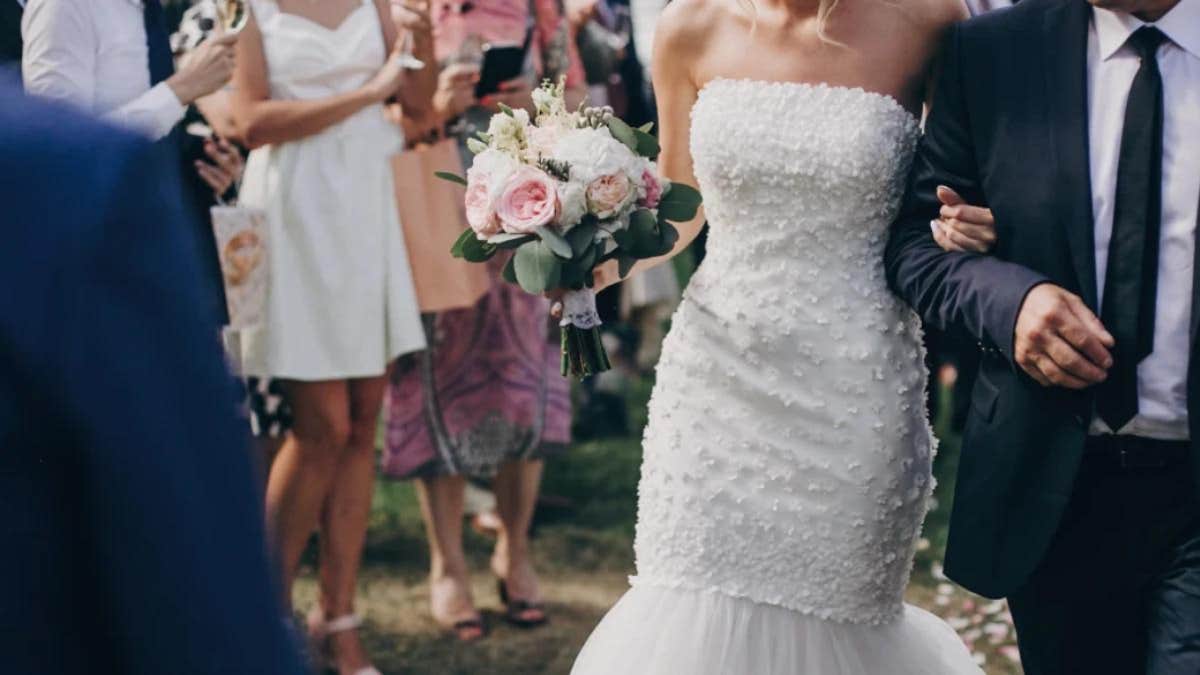 woman on her wedding day, walking down aisle