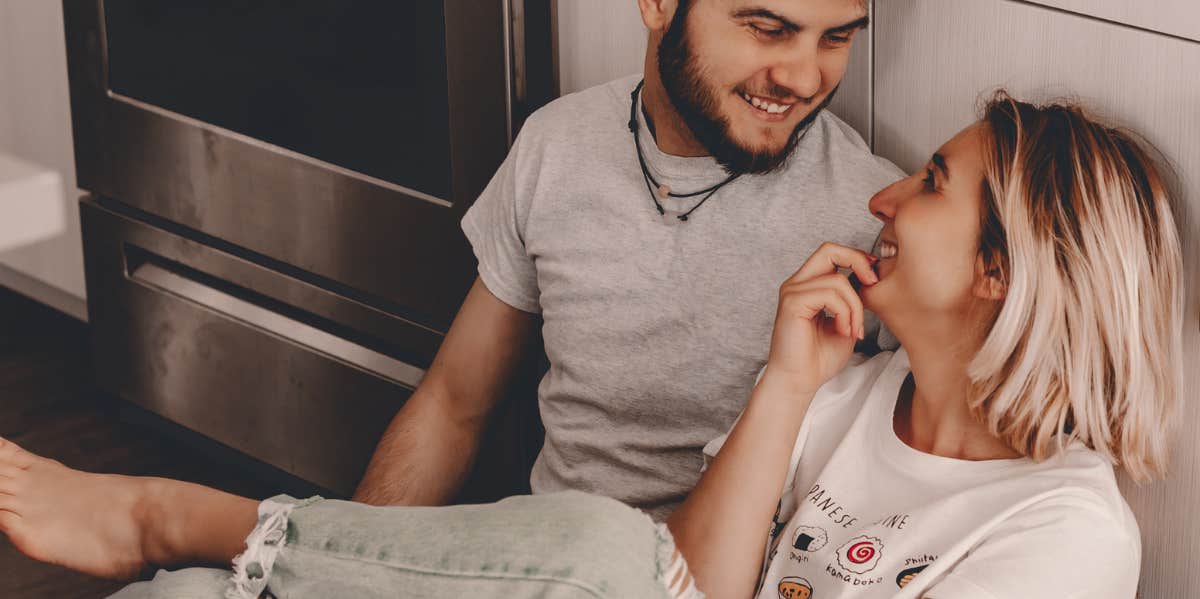 Couples Who Engage In This Activity Twice A Week Earn More Money, According To Research couple sitting on the floor together