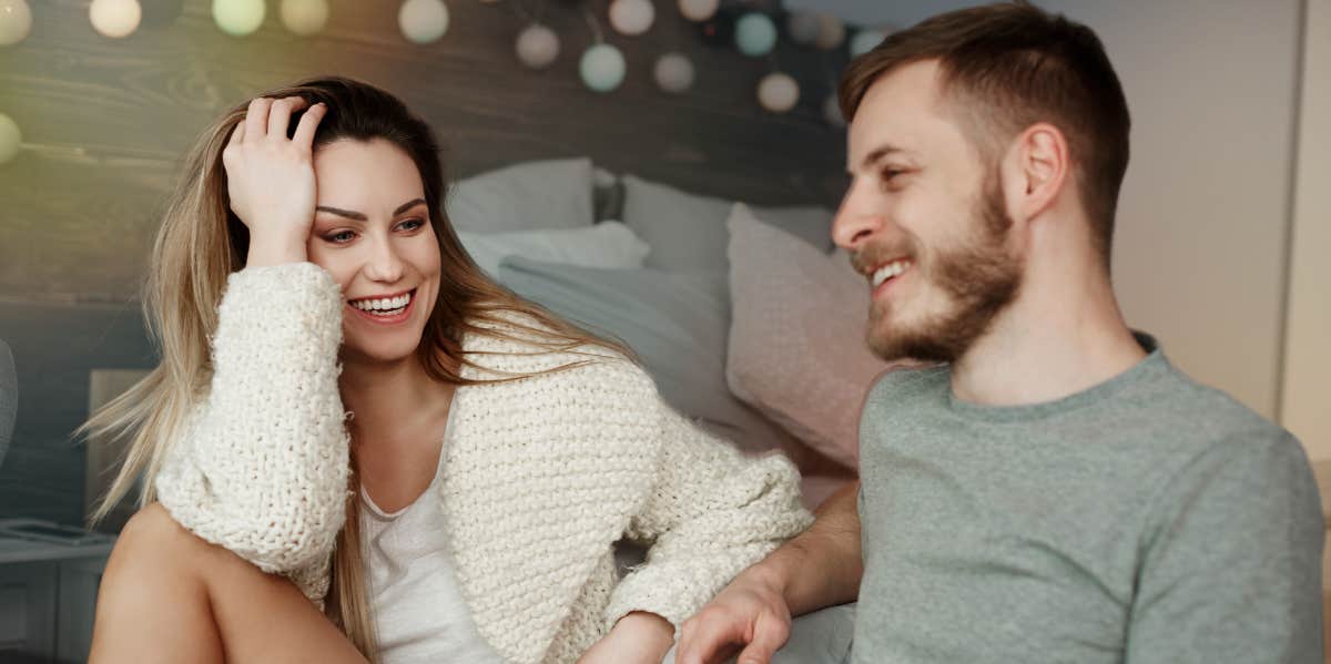 Couple sitting on the floor laughing with each other