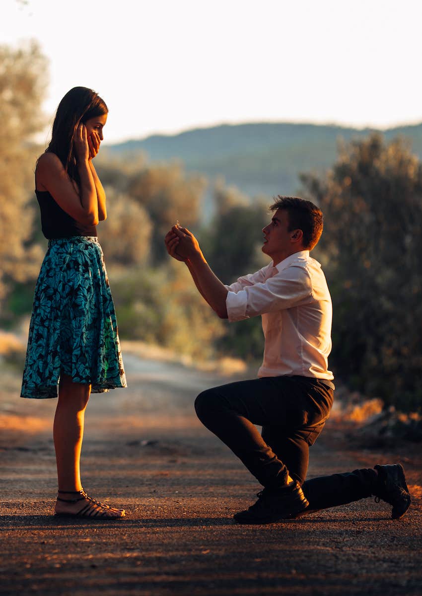 man proses on one knee in rural setting
