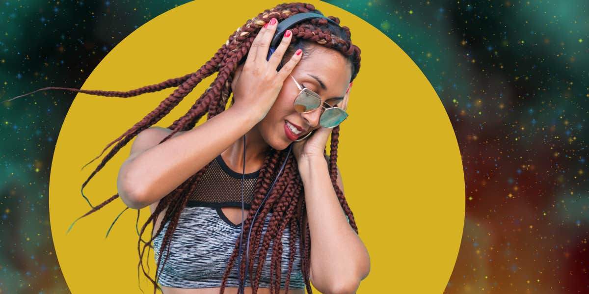 Why Extroverts Aren't As Popular As They Think They Are, According To Research woman listening to music being outgoing