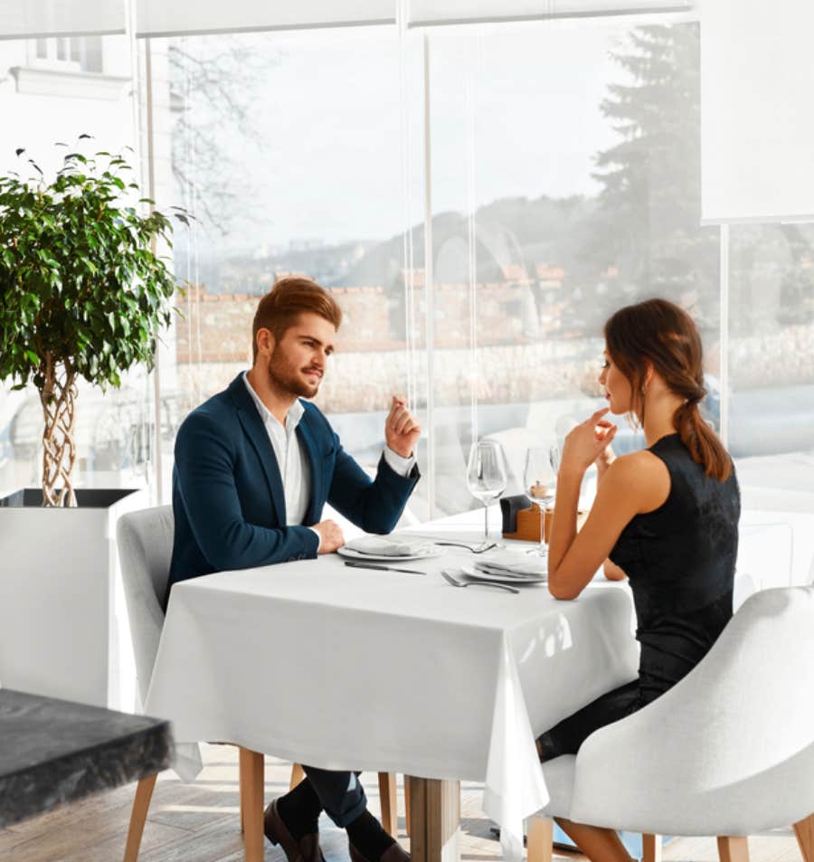 man and woman at fancy dinner table