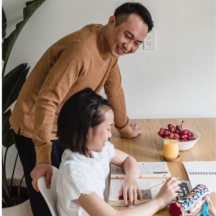 dad doing homework with daughter