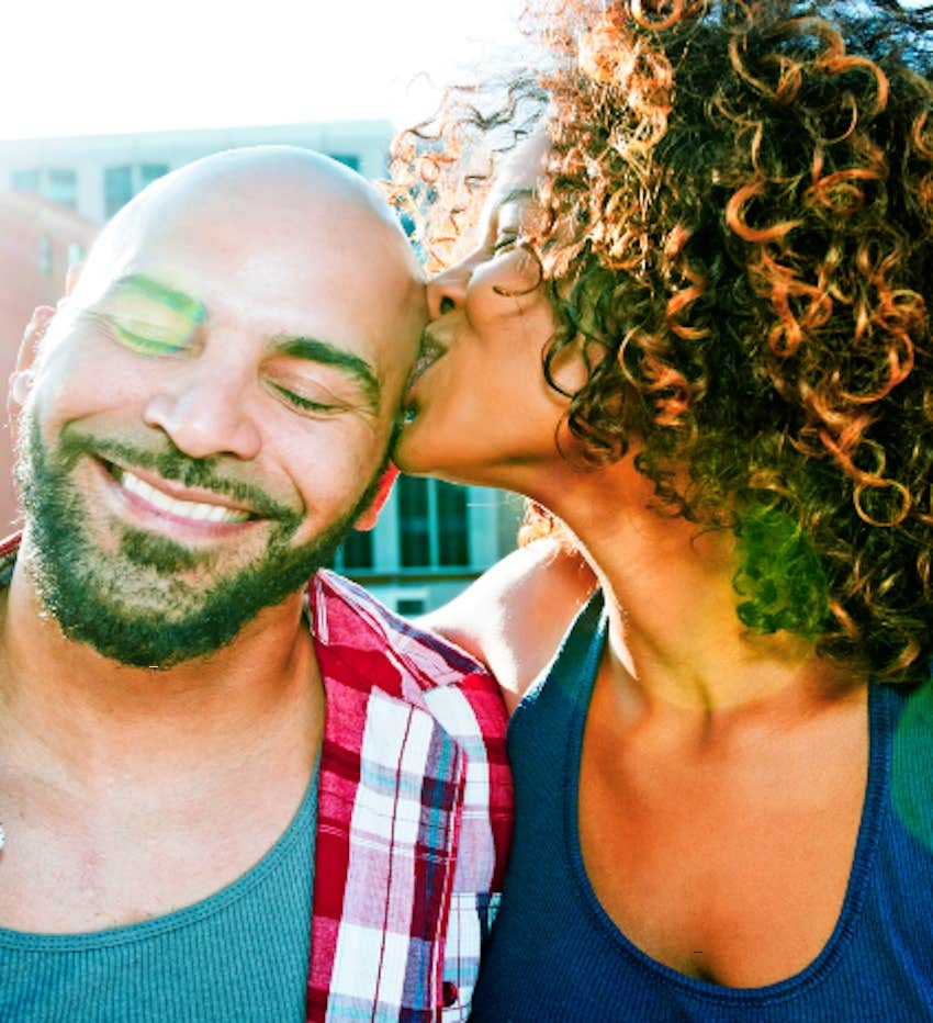 happy couple kiss in the sunlight