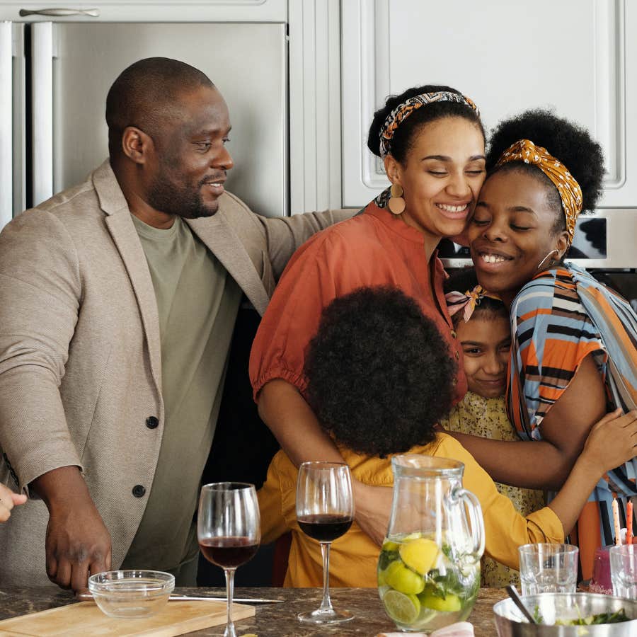 family hugging in the kitchen