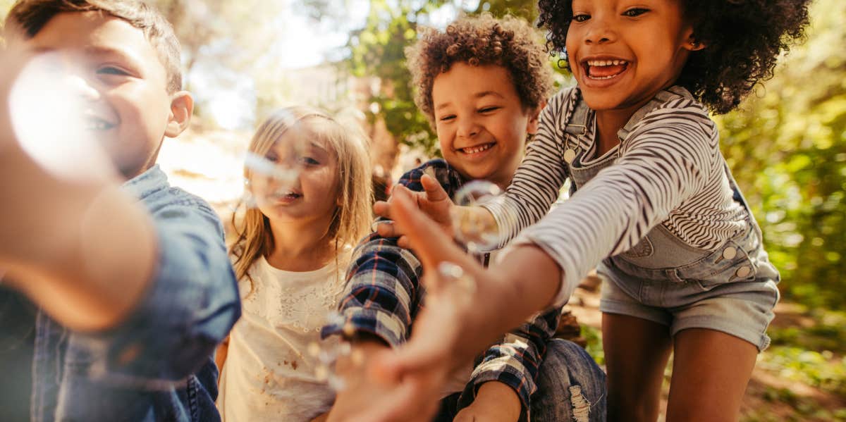 Having This Amount Of Kids Is The Least Stressful, According To Research neighborhood kids playing together