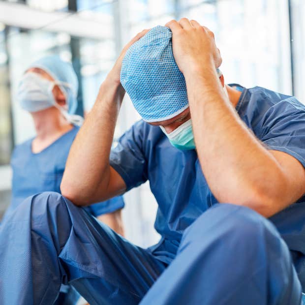 nurse with head in hands