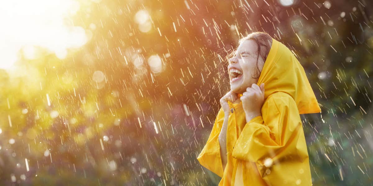 little girl in a golden rain jacket, as it rains.