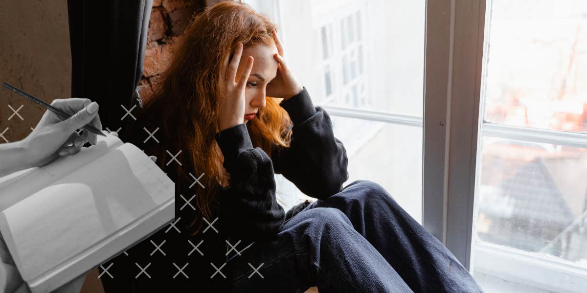 depressed woman sitting by window