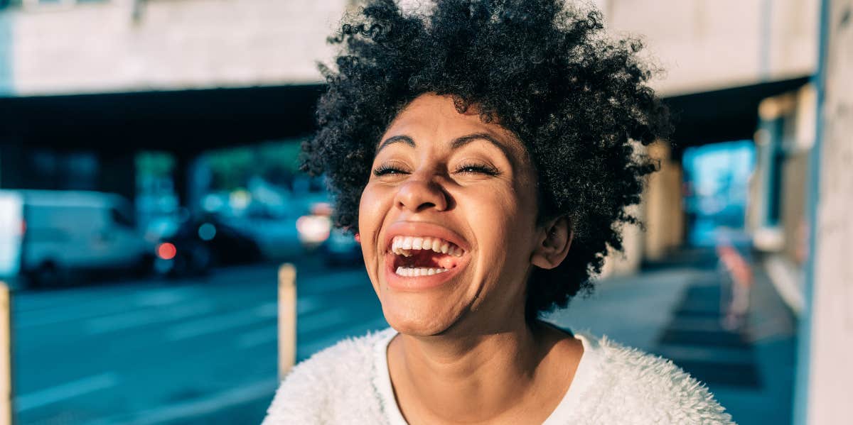 10 Ways To Feel Genuinely, Truly, Radiantly Happy (When It Feels Out Of Reach) woman laughing
