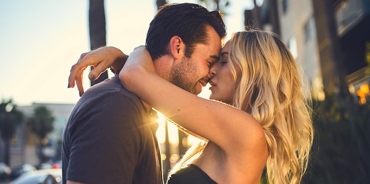 Man and woman kissing passionately in the street