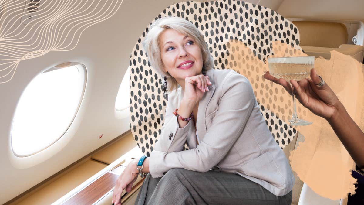 mature woman flying first class and getting wine
