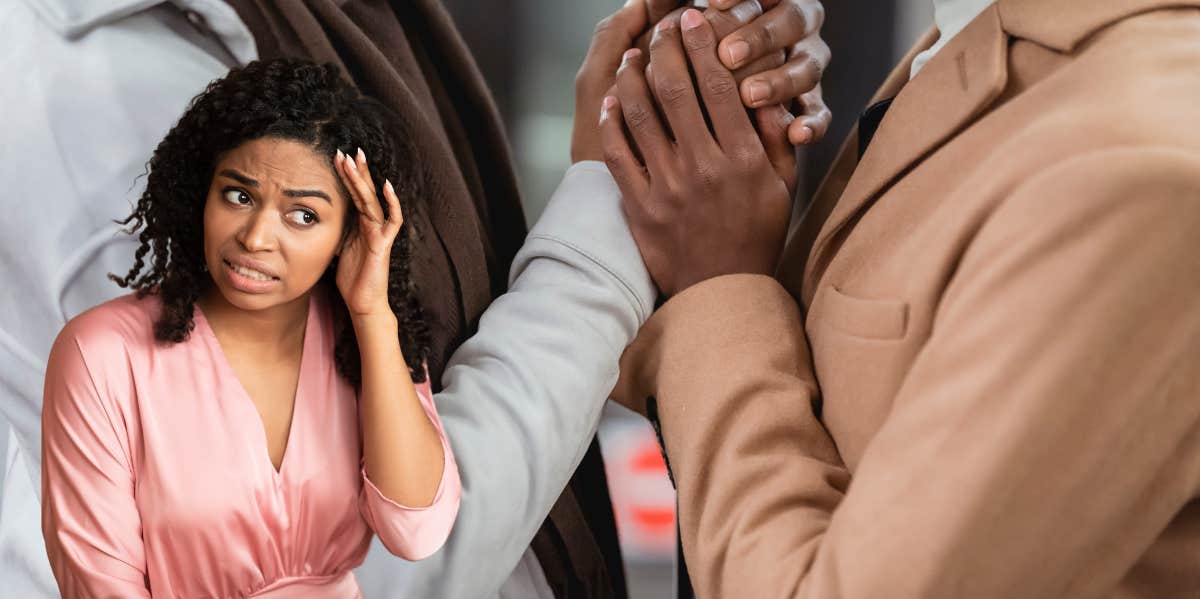 Why I Refused To Serve As A Surrogate For My Best Friend And His Partner woman with a shocked expression as her friend and his partner grasp each others hands in anticipation