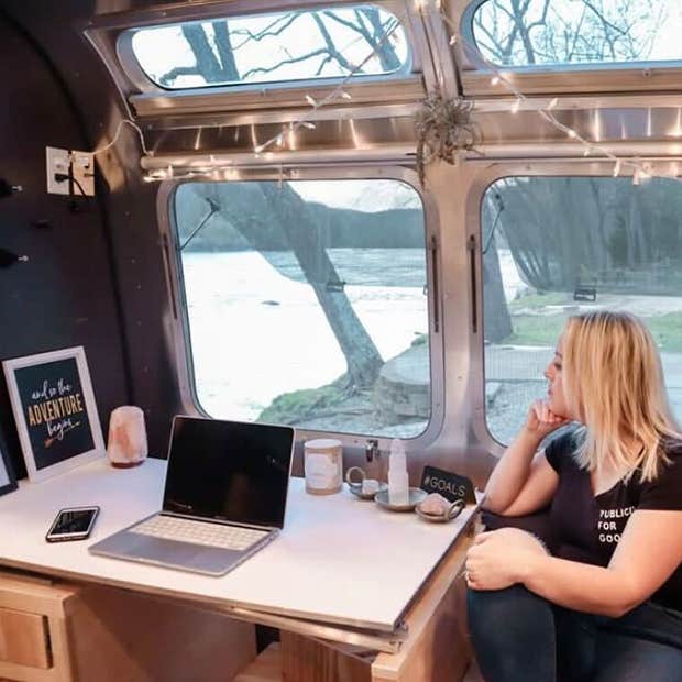 Heather&#039;s side view photo while sitting on her work table inside her Airstream