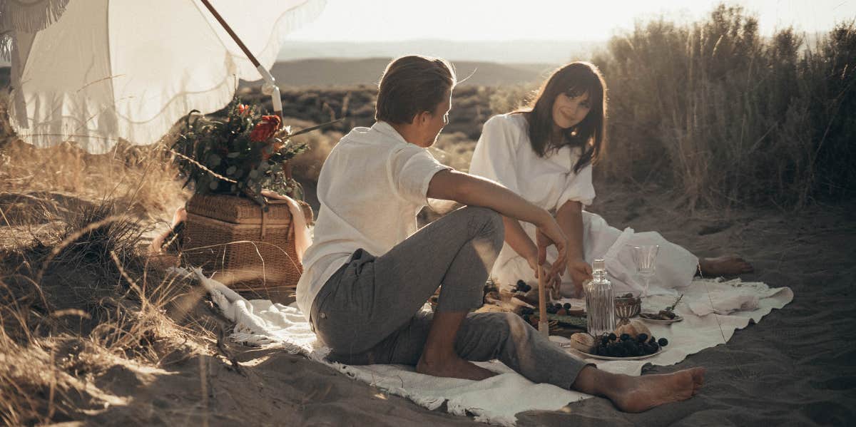 Couple eating lunch in a field