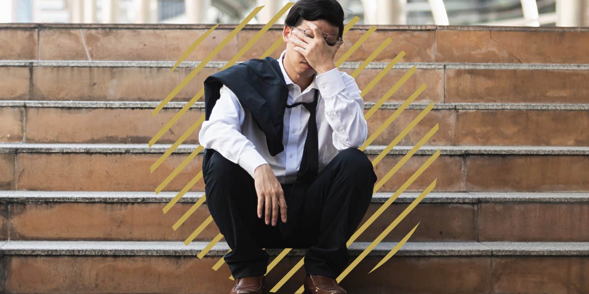 The Main Reason Wives Divorce Their Husbands, According To Research unemployed man, sitting on tsteps outside with his hands rubbing his eyes