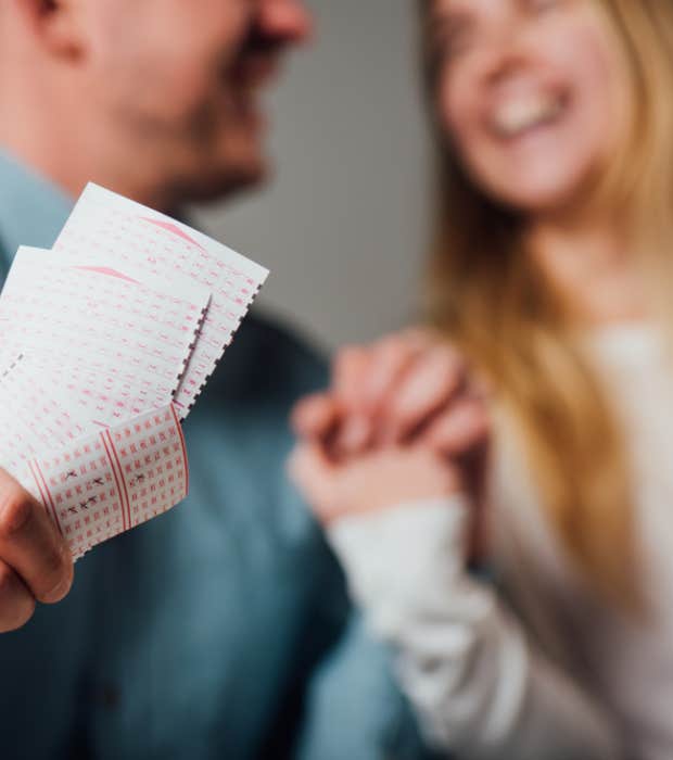 couple celebrating with lottery ticket